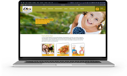 ein Apple Macbook aufgeklappt mit der DLS Webseite auf dem Bildschirm